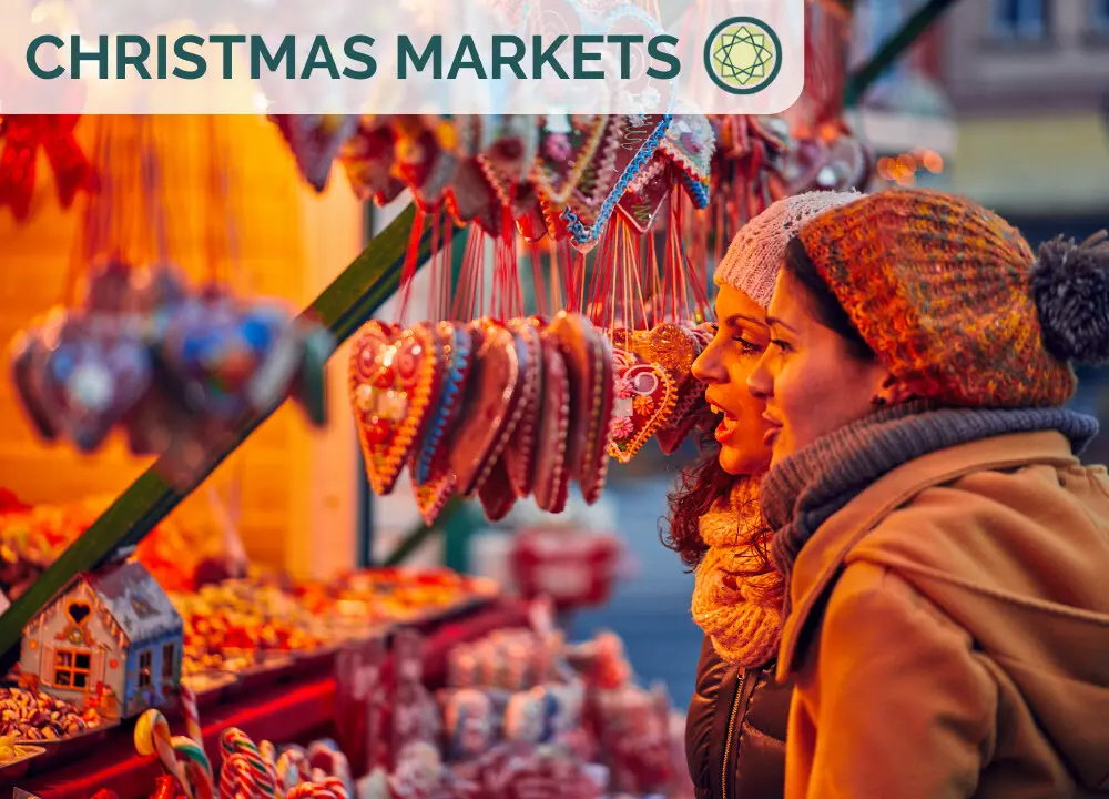 chistmas market two young women looking at a candy stall